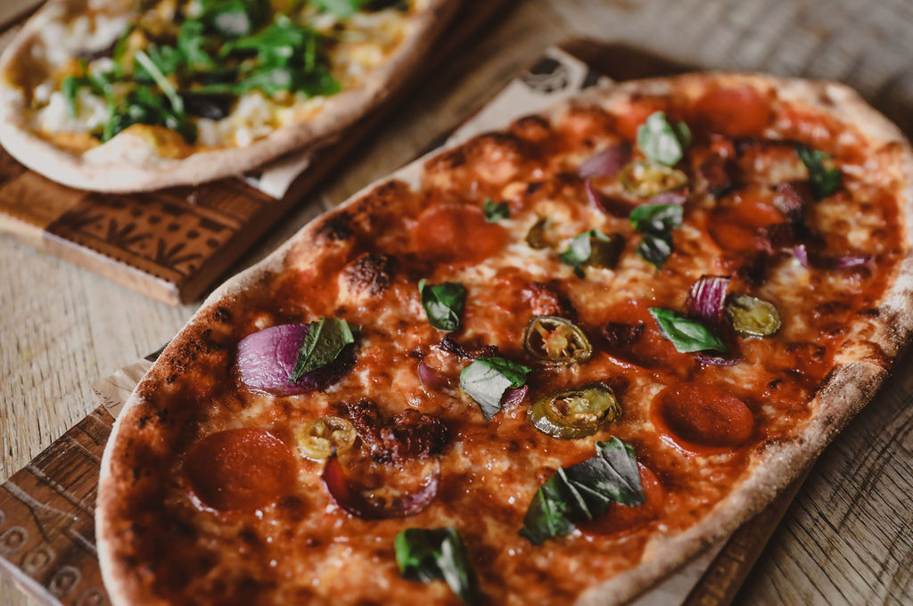 Tomato pizza on a wooden board