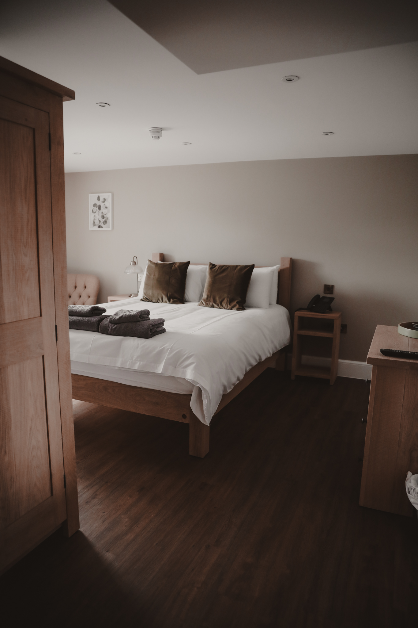 large bedroom with wooden floors and a double bed
