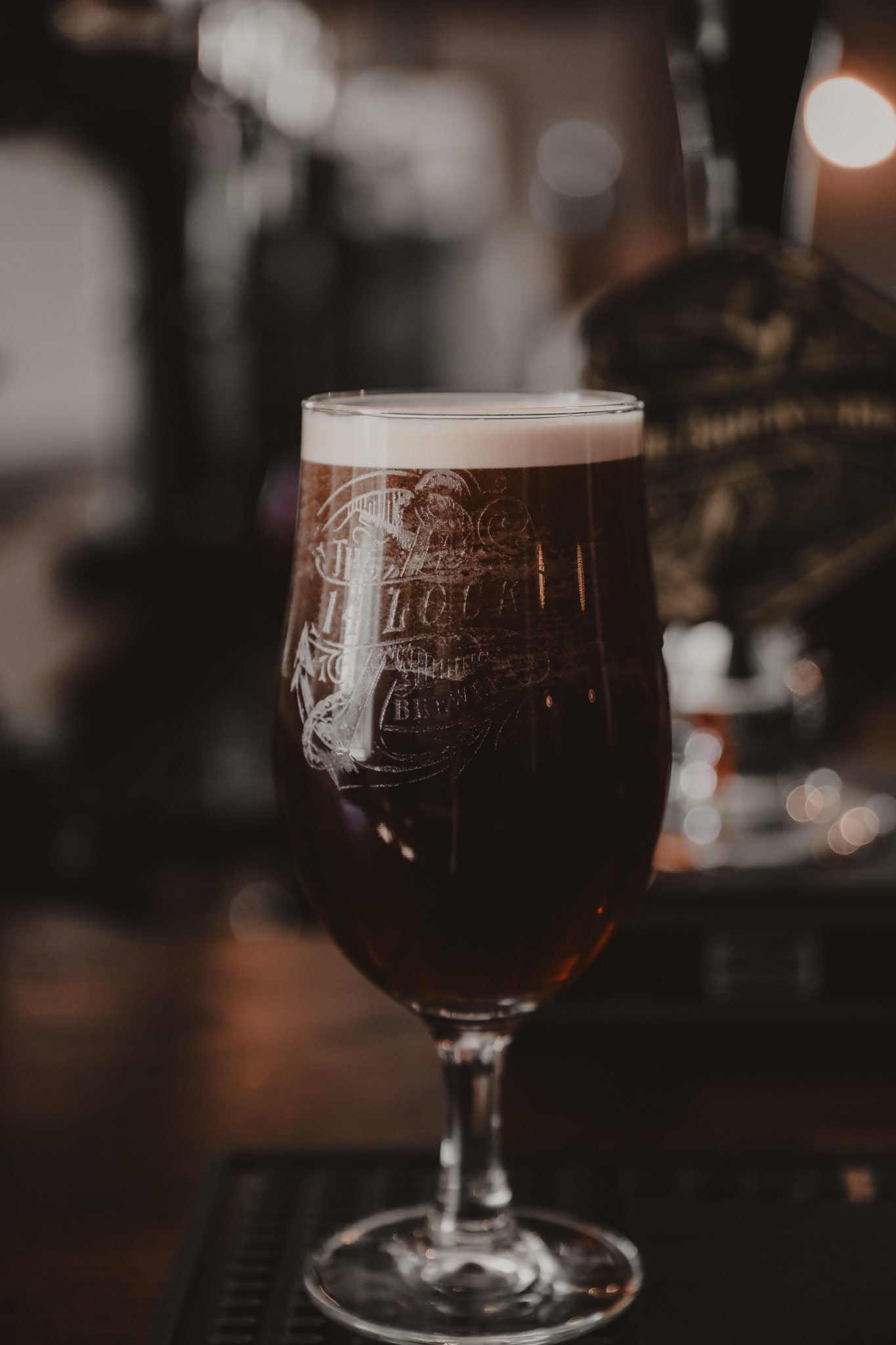 dark pint of beer in a tulip glass